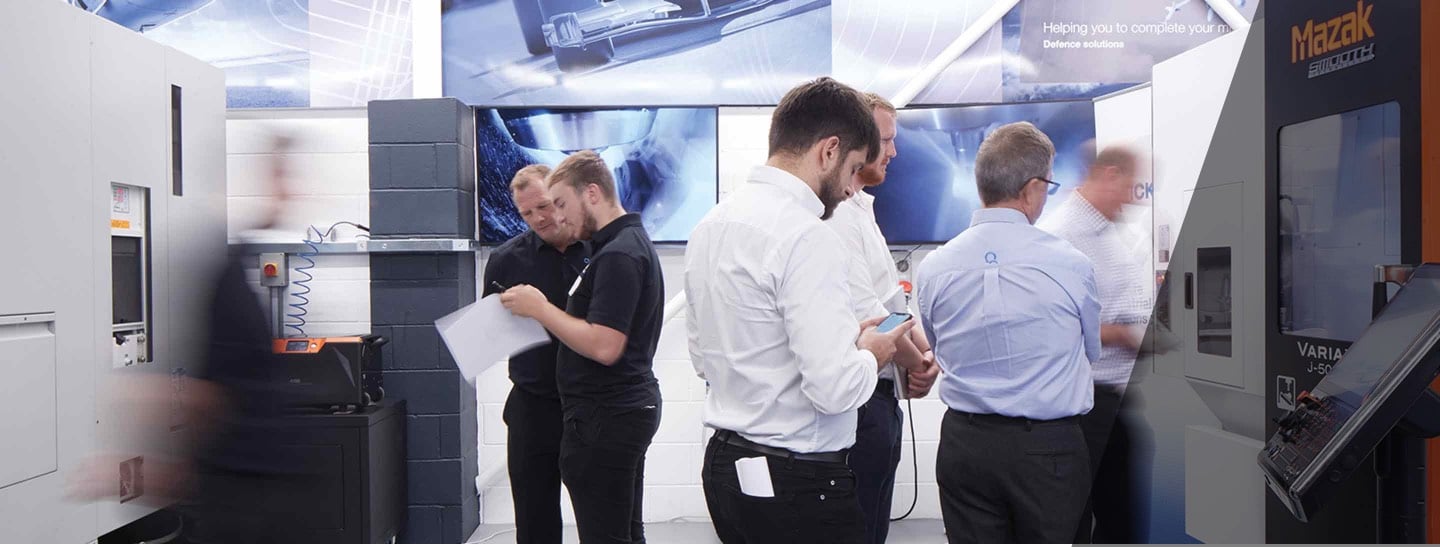 an image of 5 people working in Quickgrind manufacturing plant and demonstrating how the tools work.